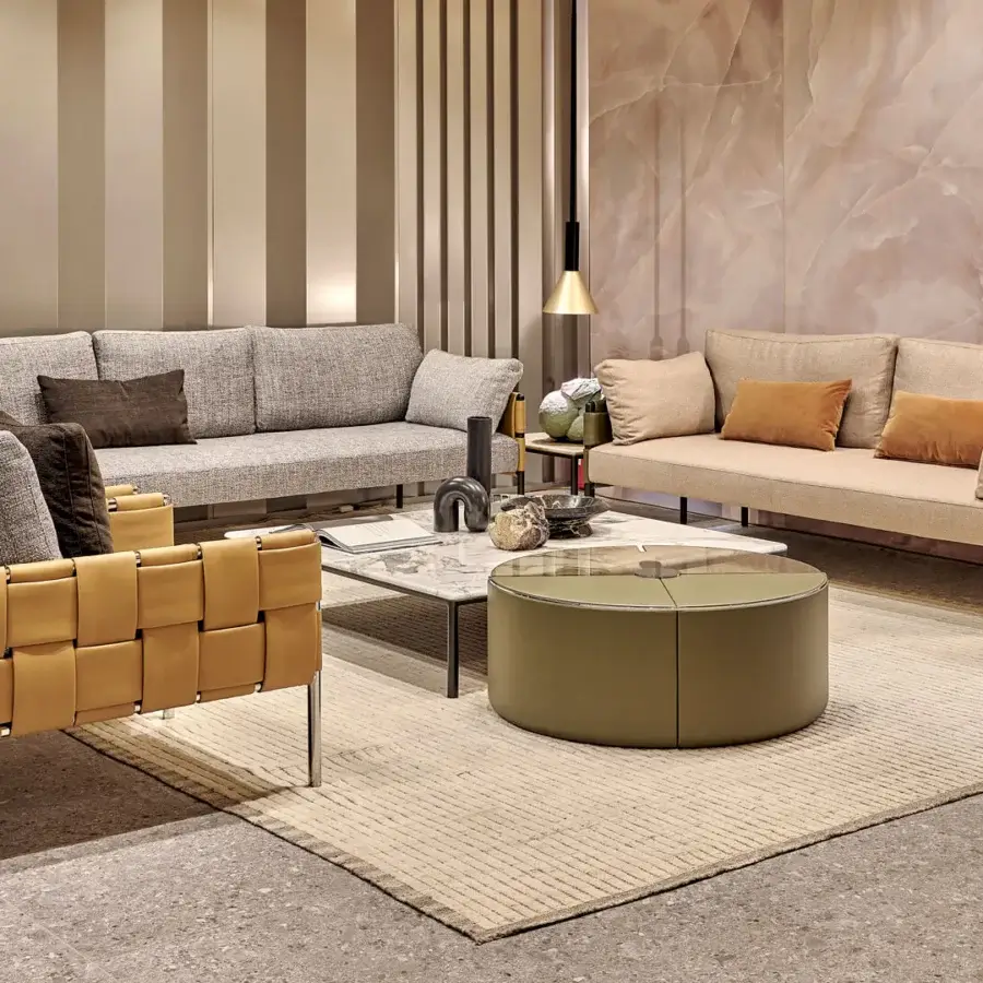 Distinguished Turri Ratio lounge chair with soft gray cushions and woven tan leather exterior with polished metal legs