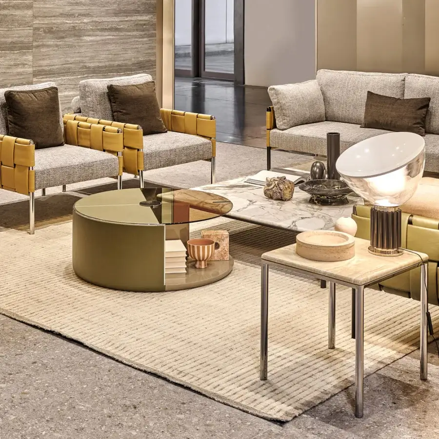 Elegant Turri Ratio lounge chair with light gray textile and tan woven leather armrests in a sleek metal structure