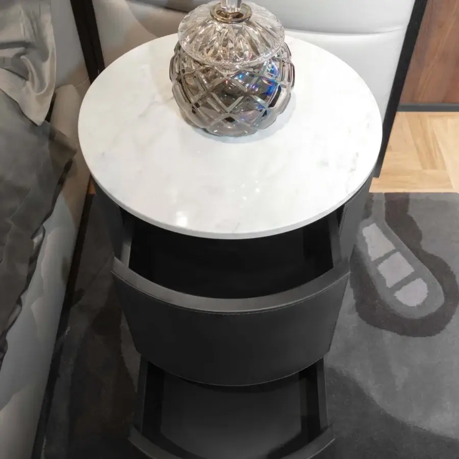 Superior Wayne Enterprises WE-076 nightstand with marble top, cylindrical dark leather body and sleek lacquered base