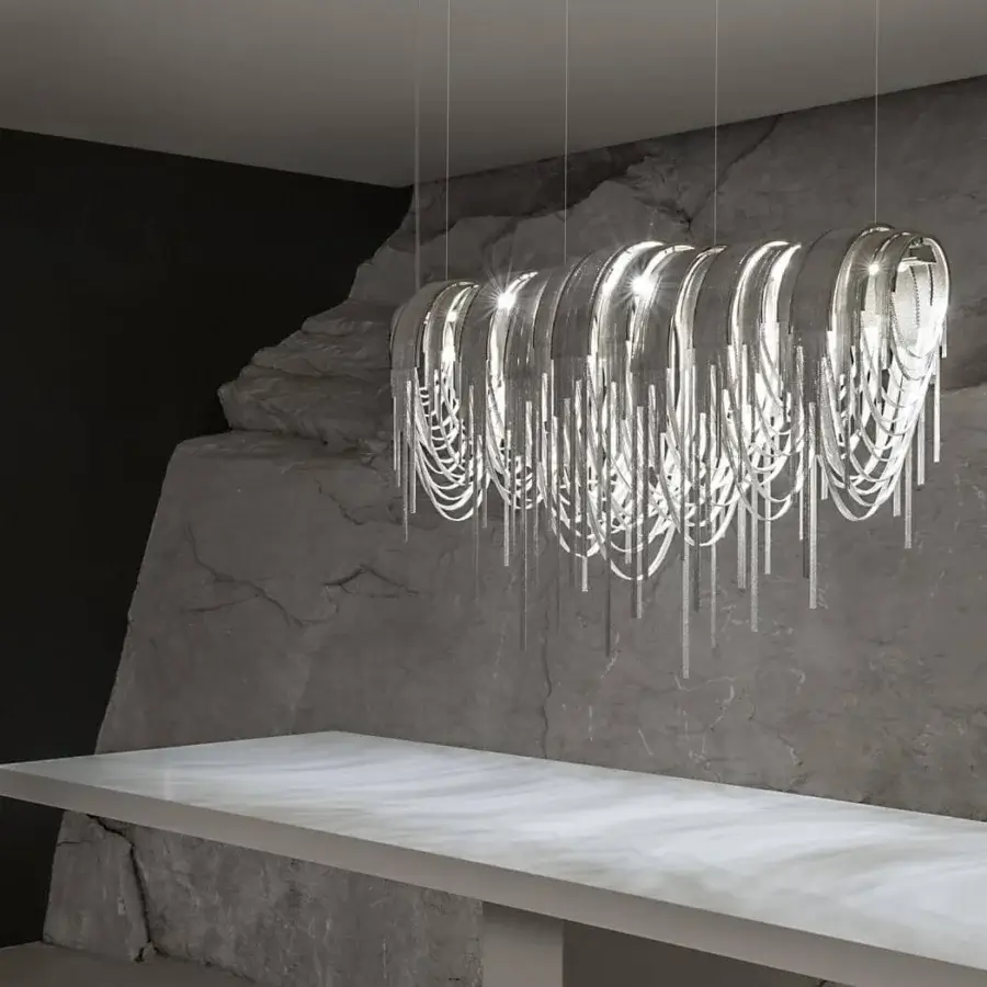 Exclusive Terzani Volver suspension lamp with cascading brass chains and glossy silver finish reflecting light