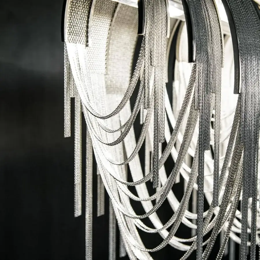 Superior Terzani Volver suspension lamp with geometric design and cascading brass chains in glossy dark metallic finish