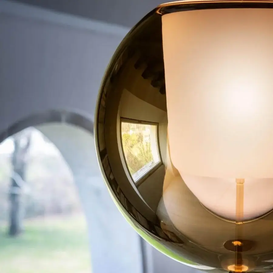 Captivating Penta Glo floor lamp with gold metal structure and refined mirrored glass outer shade, built with a sandblasted inner finish
