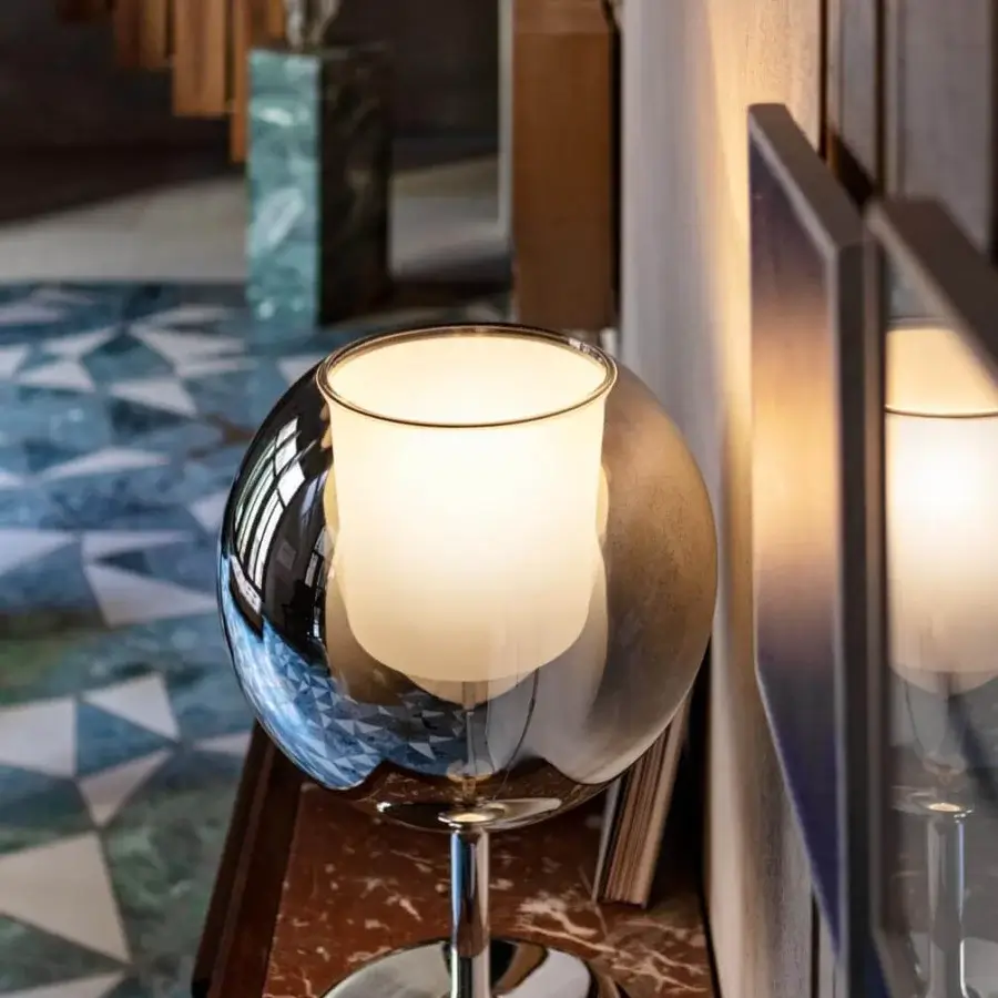 Innovative Penta Glo table lamp with refined mirrored glass and sandblasted inner shade in glossy silver metal