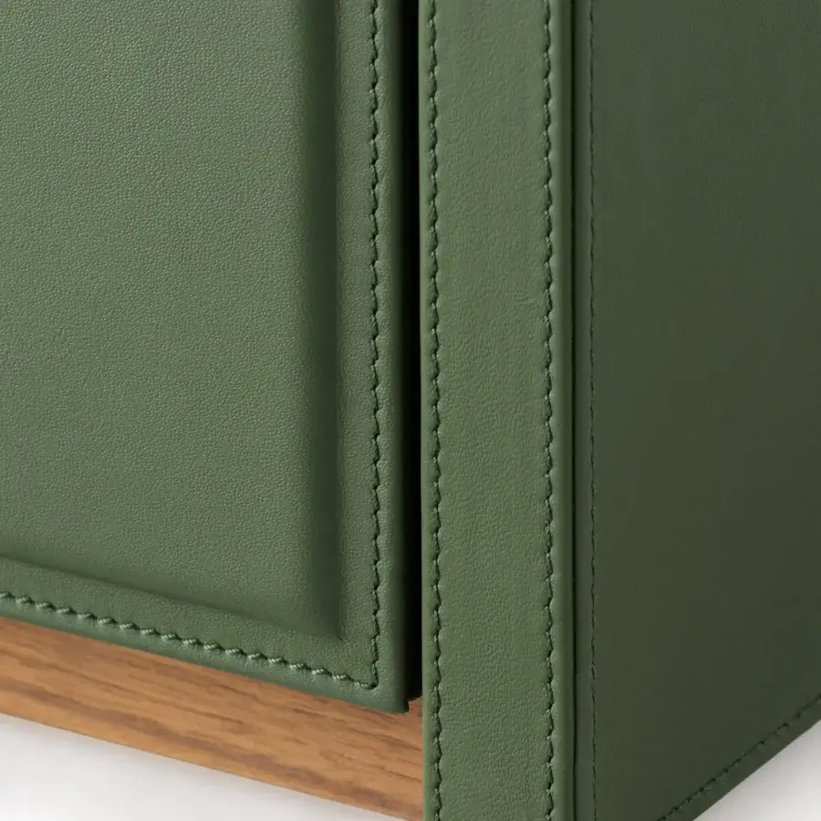Distinguished Turri Atelier nightstand with muted green leather and warm walnut wood showcasing impeccable stitching details
