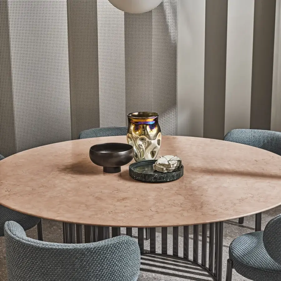 Captivating Turri Roma table with a light pink marble-like tabletop and vertically arranged dark metal base crafted with glossy lacquered wood