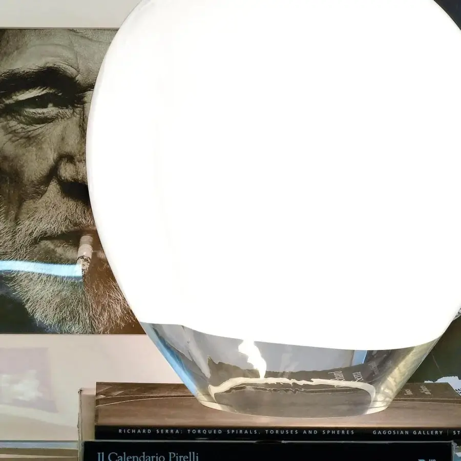 Elegant Vistosi Nessa table lamp handcrafted in transparent glass with a white upper band diffusing soft illumination