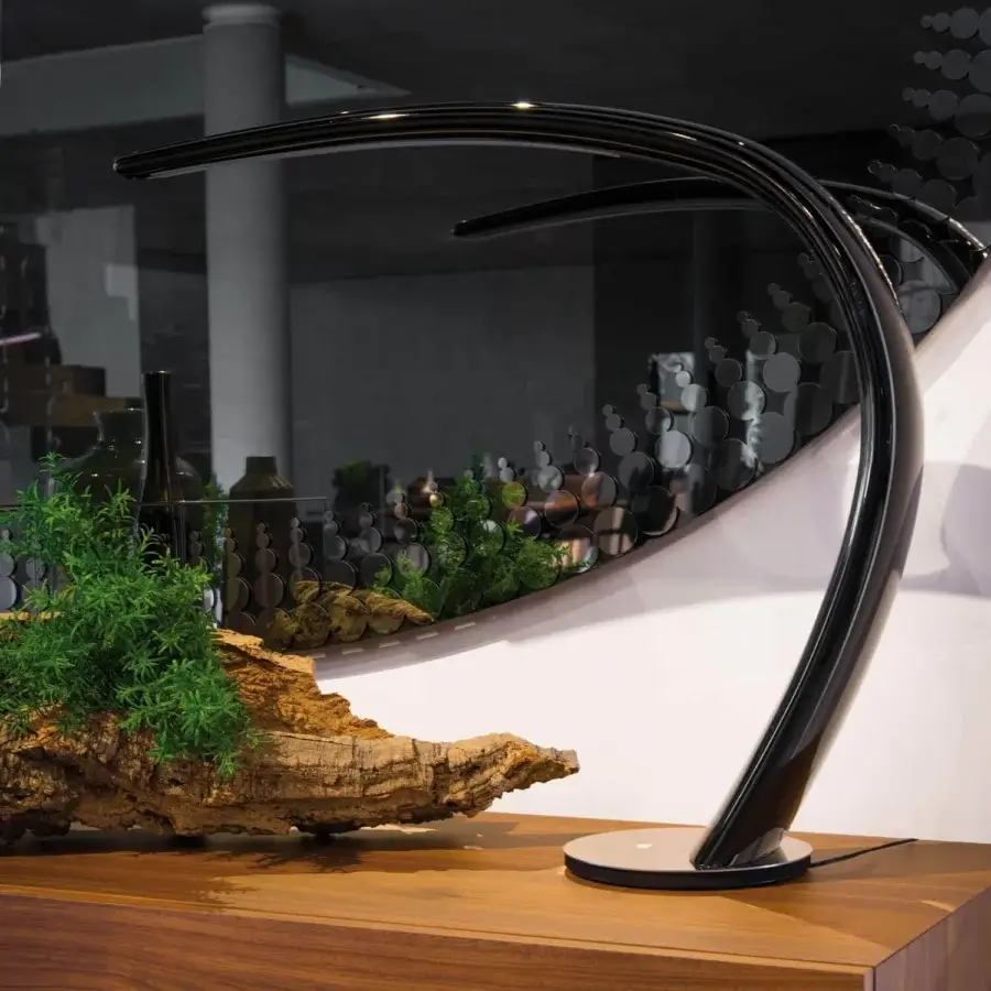 Captivating Cattelan Italia Mamba lamp with a curved silhouette crafted in polished black polyurethane and black chrome base