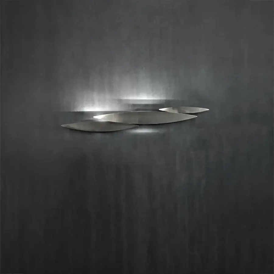 Distinguished Terzani I Lucci Argentati wall lamp recalling a school of fish crafted in brushed nickel metal with sleek leaf-shaped elements