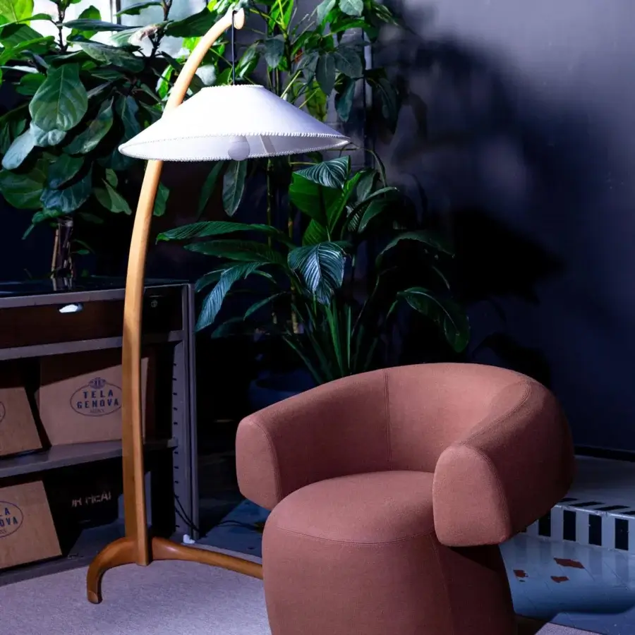 Superior Moroso Ruff lounge chair with rounded silhouette upholstered in matte brown textile and transparent PVC glides