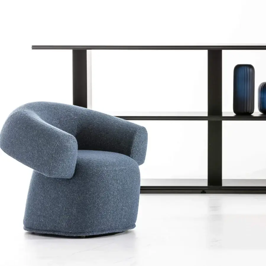 Distinguished Moroso Ruff lounge chair with compact rounded silhouette upholstered in richly textured blue textile and transparent PVC glides
