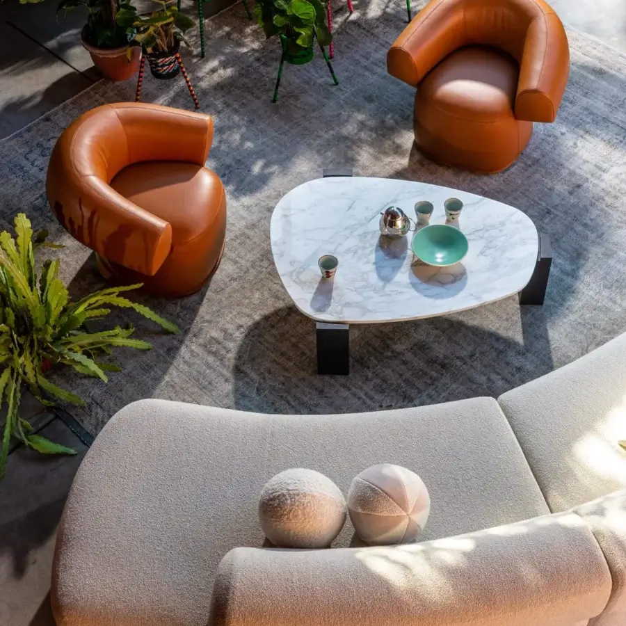 Elegant Moroso Ruff lounge chair with warm brown leather upholstery and transparent PVC glides screwed to the structure