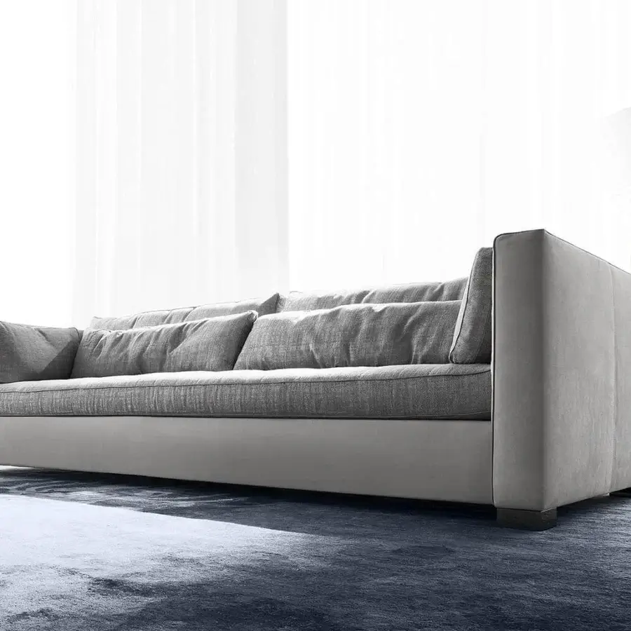 Elegant Erba Alchimia sofa upholstered in cool gray textile with a matte finish and natural goose feather cushions