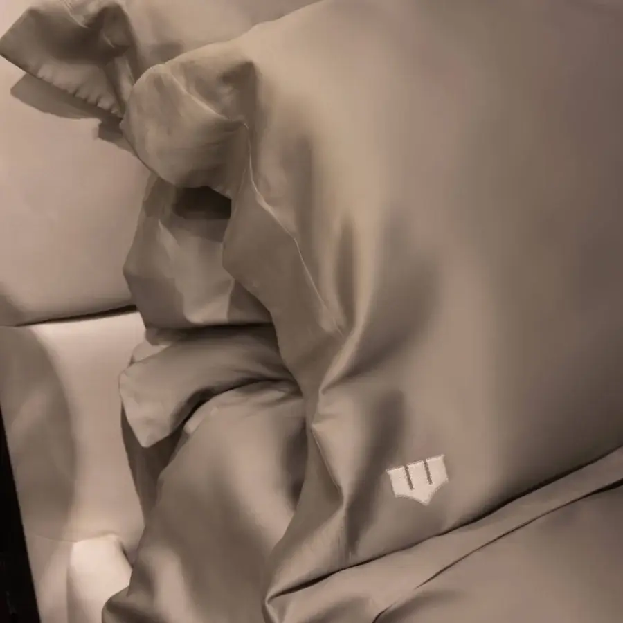 Lavish WAYNE Enterprises WE-075 bed with muted grey satin bedding and wood veneer crafted in luxurious leather upholstery