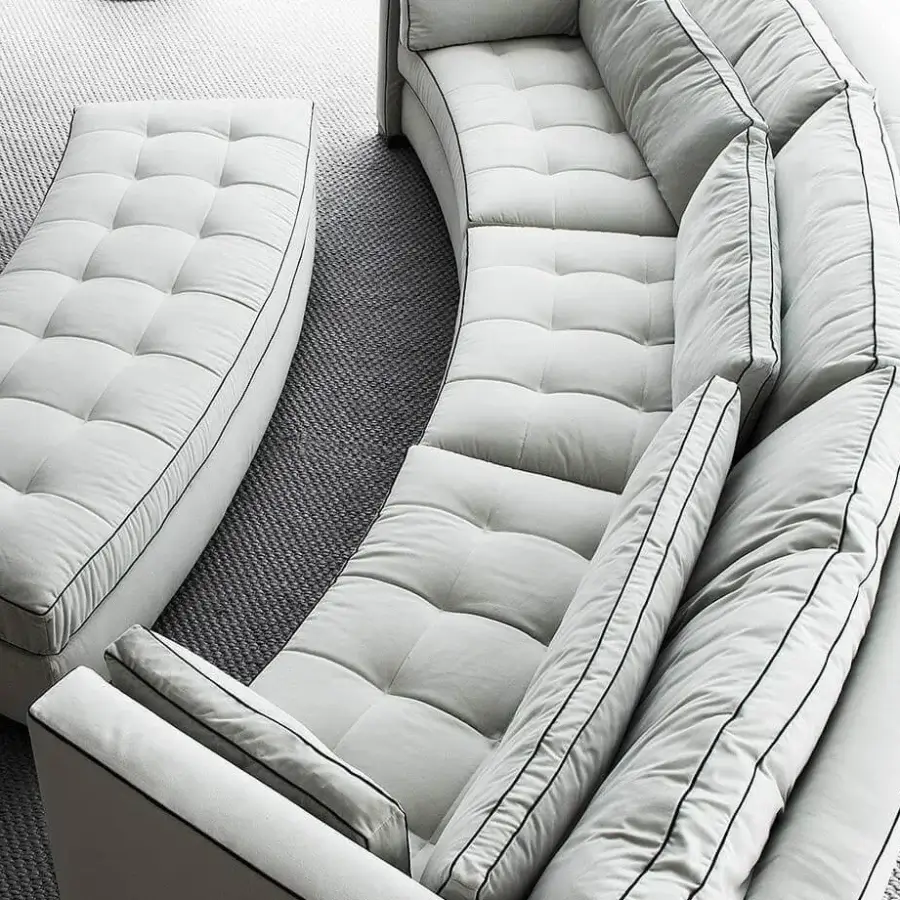 Lavish Erba Alchimia sectional with light gray textile upholstery, black piping and a button-tufted solid wood frame built for comfort