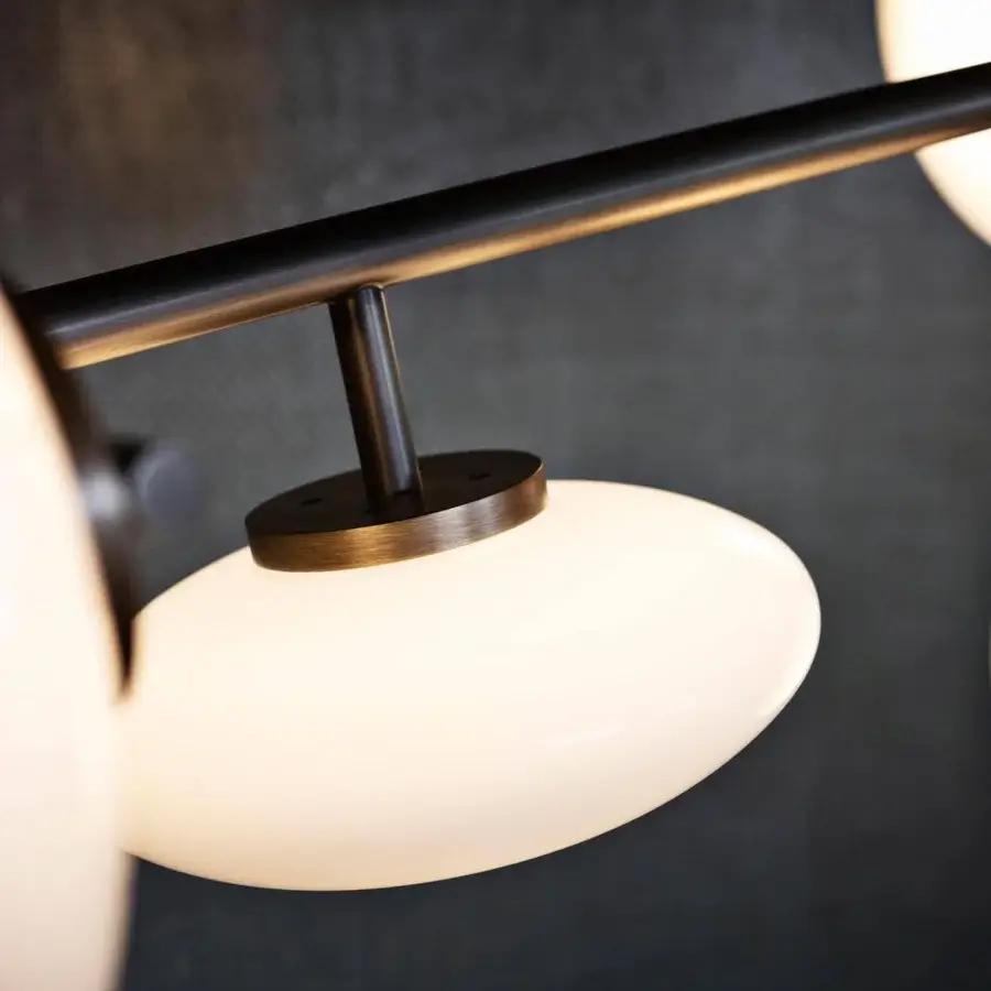Exclusive Penta Mamì suspension lamp with a matte black metal structure and spherical white blown glass diffusers