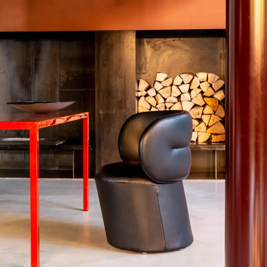 Distinguished Moroso Getlucky chair with bulbous backrest and smooth black leather or leatherette upholstery crafted in Italy