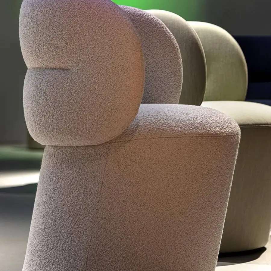 Sophisticated Moroso Getlucky chair in beige boucle textile with transparent PVC glides screwed to the structure