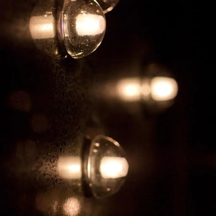 Elegant Bocci 14 Surface Mount lamp with clear cast glass and a frosted cylindrical void exhibiting a glossy finish
