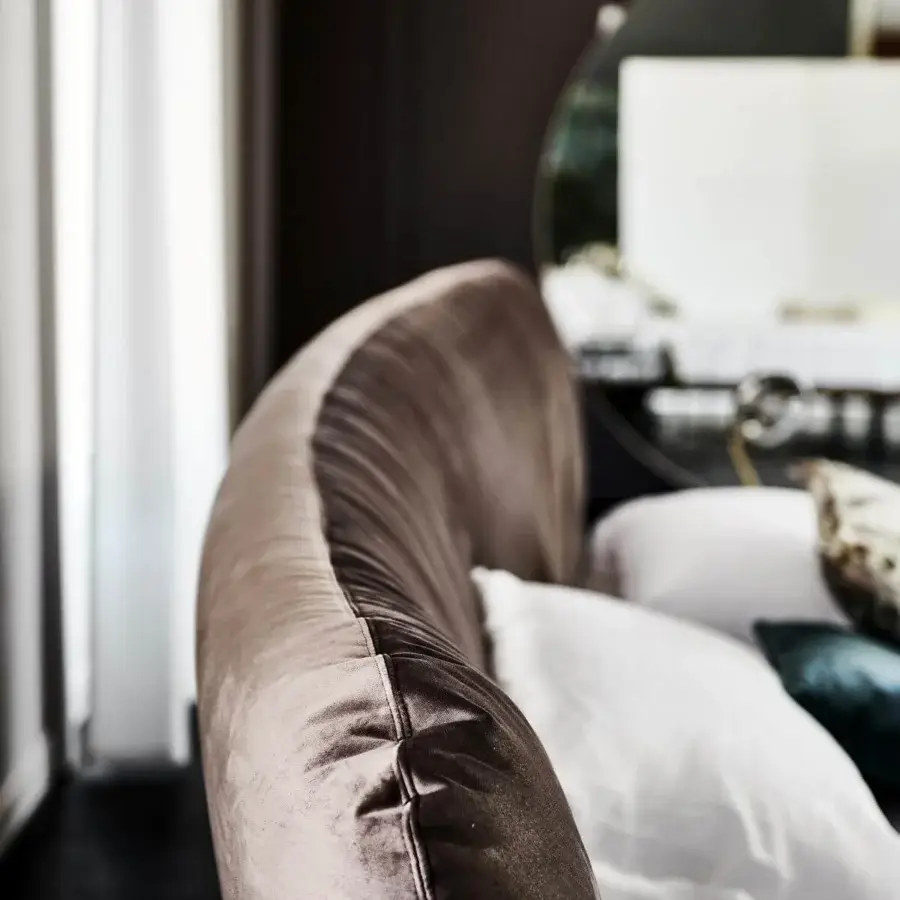 Lavish Cattelan Italia Marlon bed with a curved headboard upholstered in lustrous taupe velvet and Canaletto walnut frame