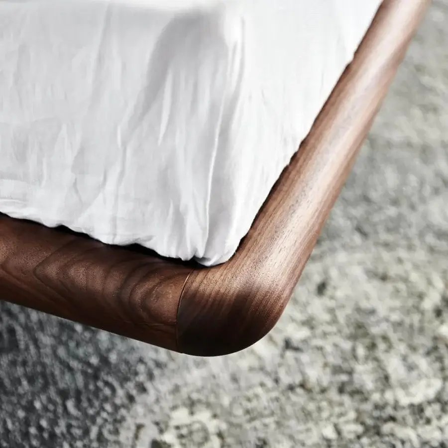Superior Cattelan Italia Marlon bed with a curved frame in burned oak stained ashwood and crisp white textile headboard