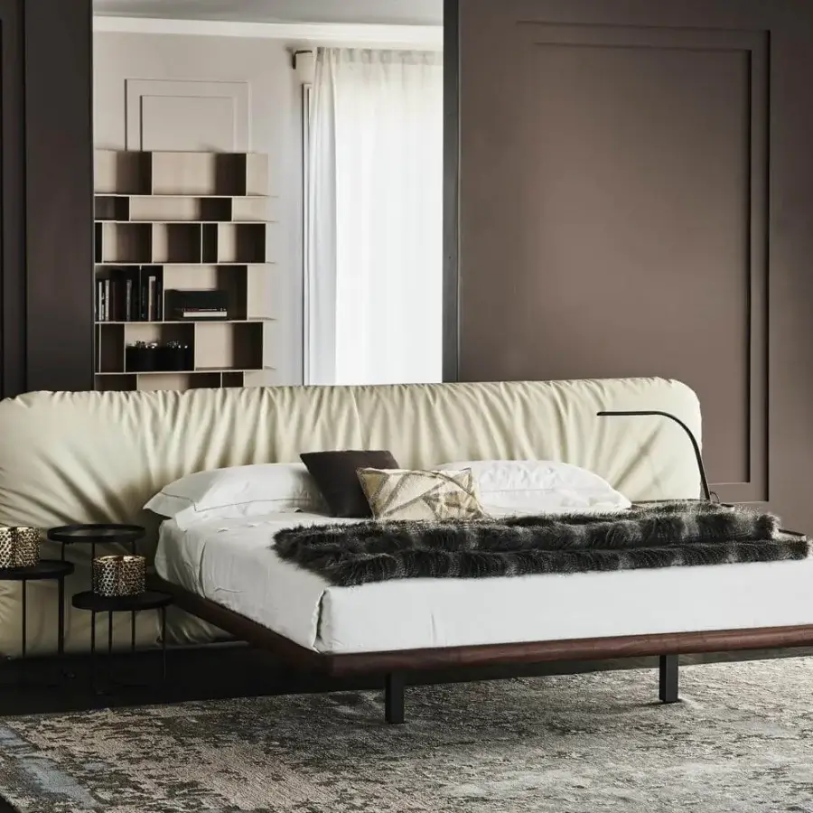 Elegant Cattelan Italia Marlon bed with burned oak stained ashwood frame and light cream textile upholstery supported by black metal legs