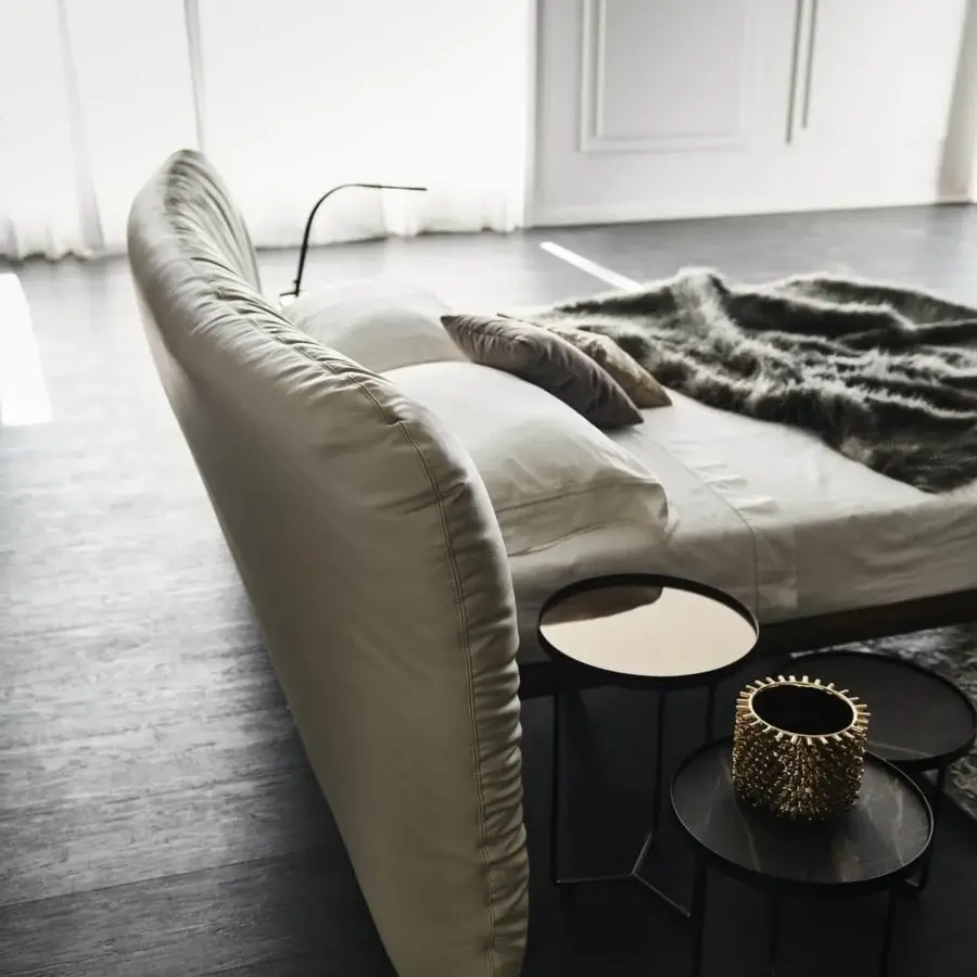 Elegant Cattelan Italia Marlon bed with a Canaletto walnut frame and thickly padded light-colored textile upholstery