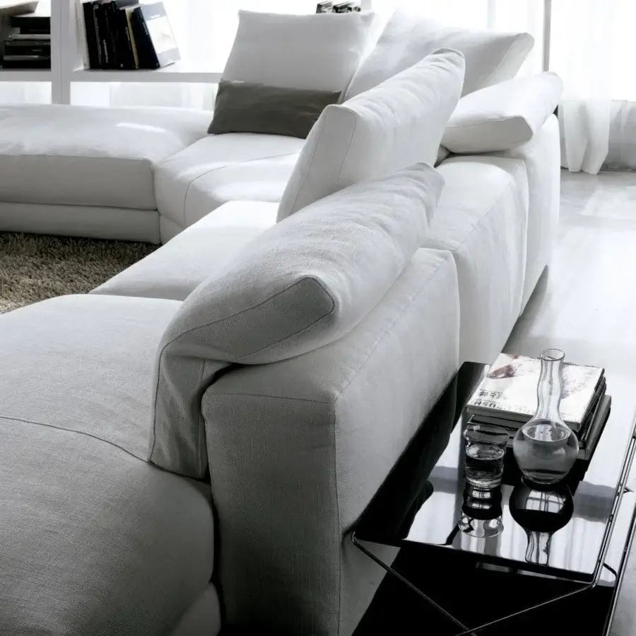 Lavish Swan Italia Hills sectional with white woven removable fabric and oversized feather cushions crafted with a powder-coated metal frame
