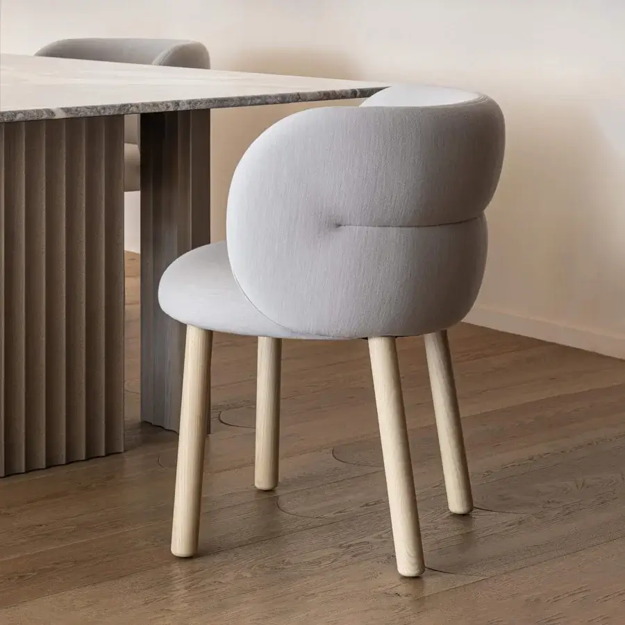 Distinguished Moroso Getlucky chair with light gray upholstery in a matte finish and solid varnished ash wood frame