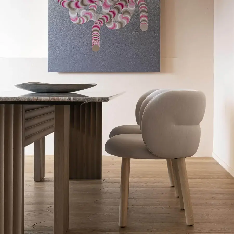 Superior Moroso Getlucky chair with light grey textile upholstery and varnished ash wood legs