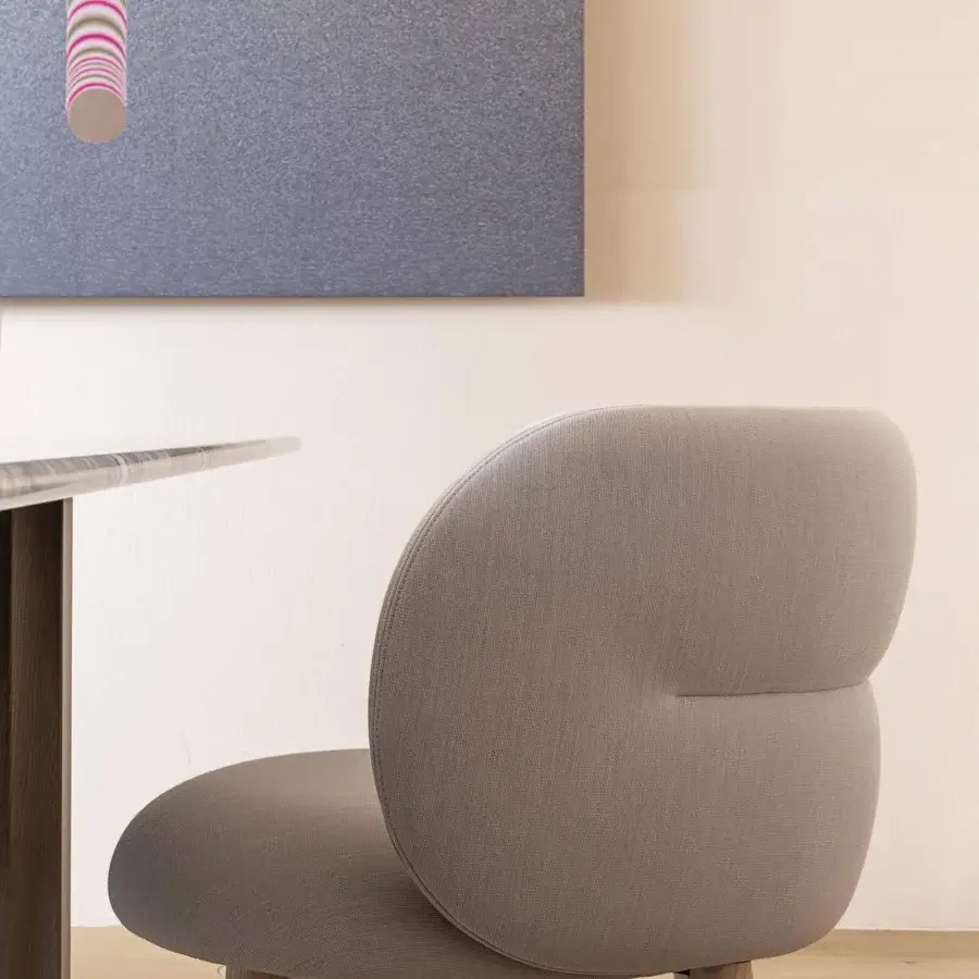 Elegant Moroso Getlucky chair with rounded silhouette in matte gray textile and varnished ash wood legs