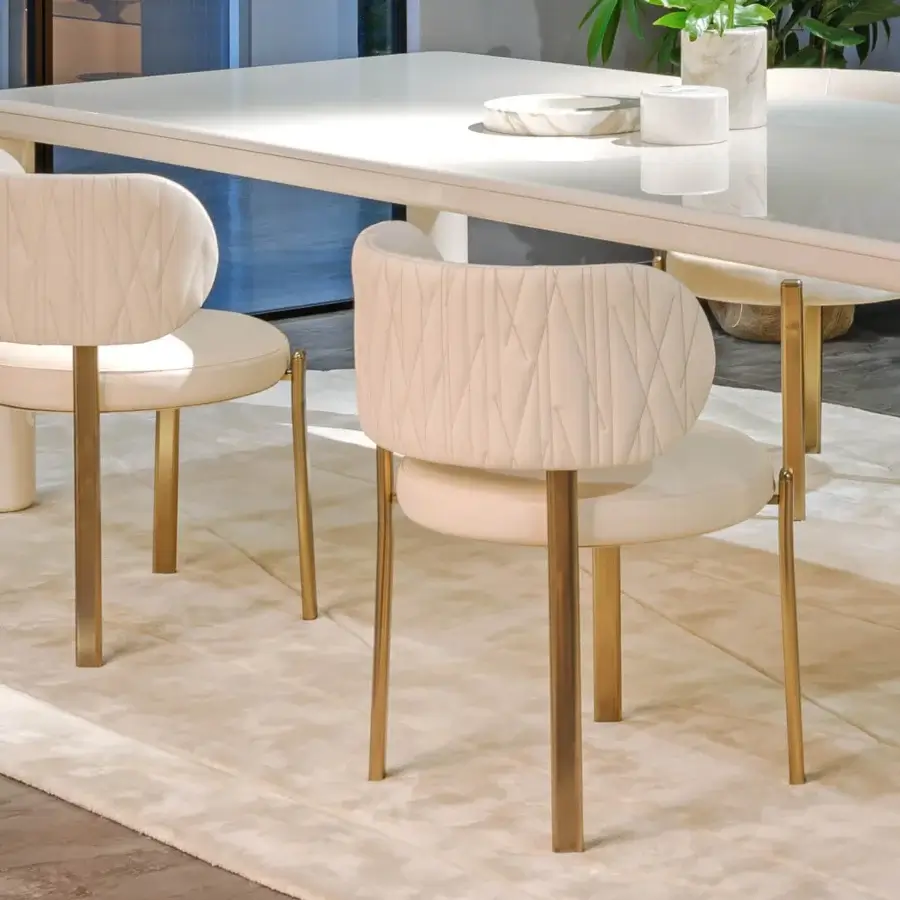 Distinguished Turri Roma chair with a rounded silhouette in light beige textile upholstery and glossy metal legs