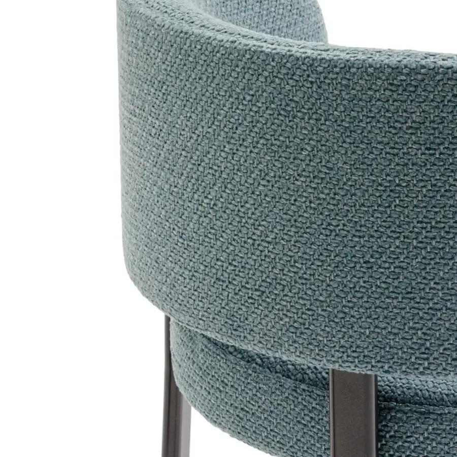 Elegant Turri Roma chair with rounded form and smooth blue-green woven textile upholstery crafted with sleek refined metal legs