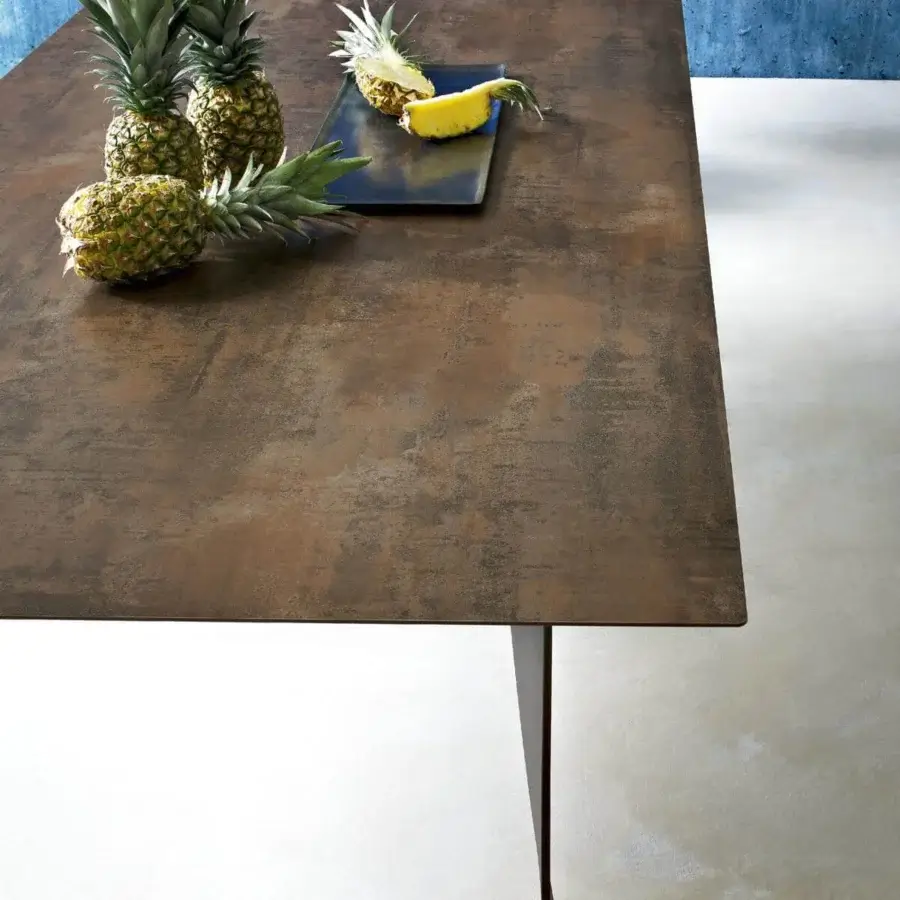 Exceptional Roberti Rattan Hamptons Graphics table with a weathered, mottled HPL top and twisted powder-coated metal legs