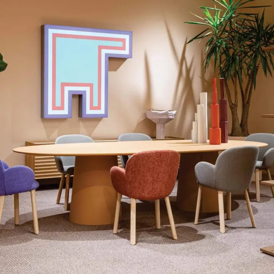 Elegant Moroso Tulp armchair with rounded silhouette upholstered in rust-red textile and anchored with ash wood legs built with a steel frame