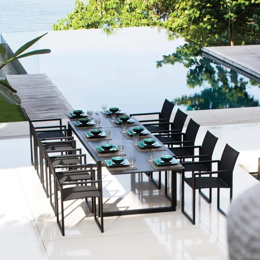 Elegant Royal Botania Ninix extendable table with a dark matte surface and robust dark metal frame