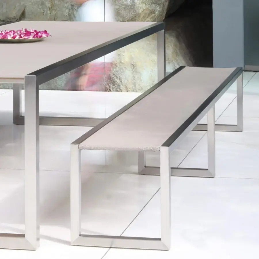 Elegant Royal Botania Ninix table with a light gray finish and brushed stainless steel frame
