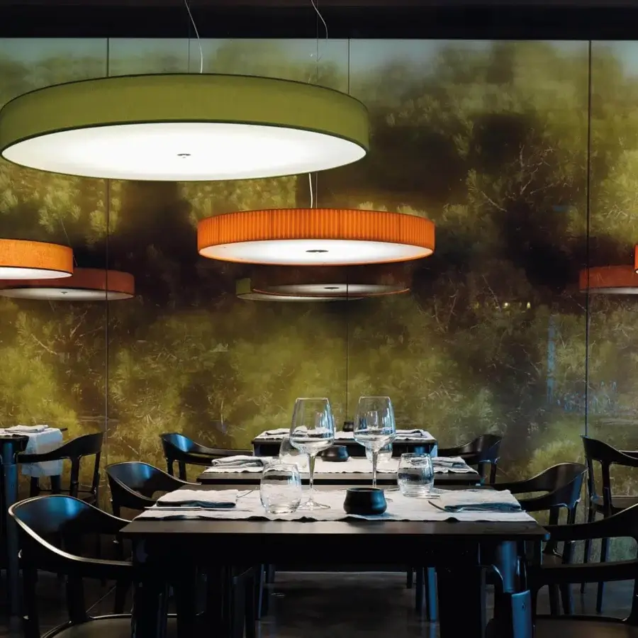 Exceptional Modo Luce Discovolante suspension lamp with an orange textile shade and white internal diffuser embodying minimalist design