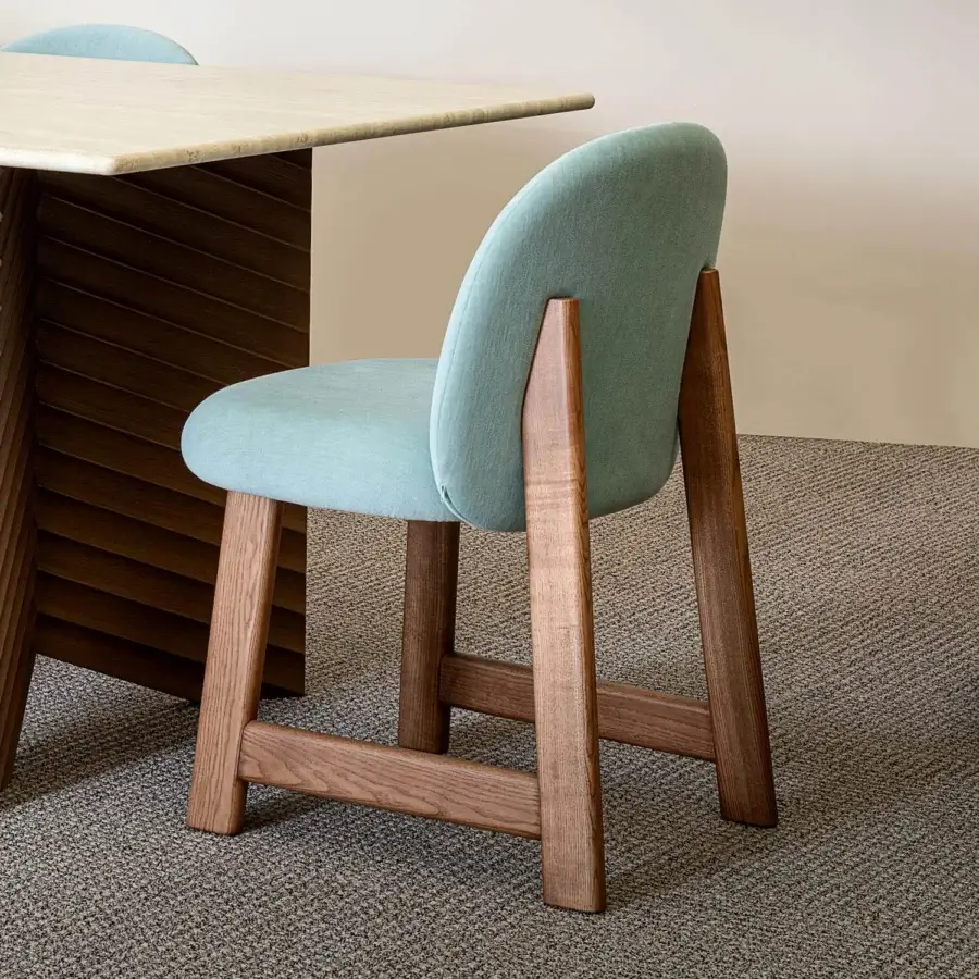 Elegant Moroso Pheaby chair with light blue textile upholstery and painted ash trestle-like legs embodies Italian design
