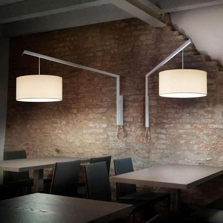 Distinguished Modo Luce Angelica wall lamp with a cylindrical textile lampshade and black painted metal arm