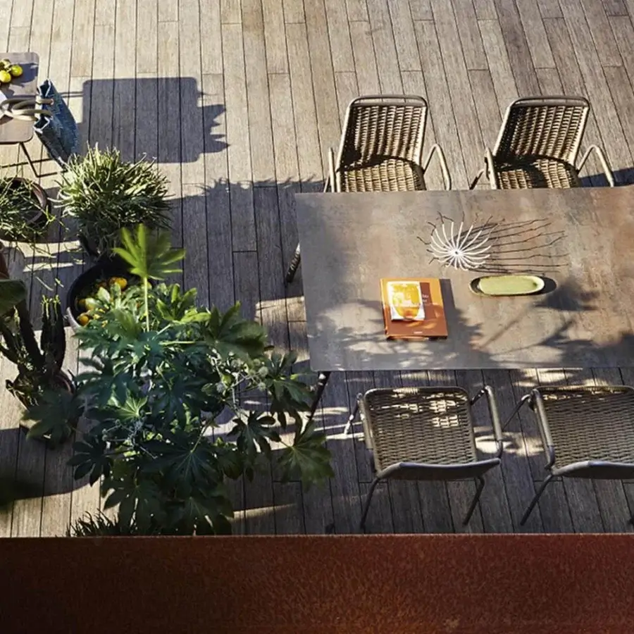 Superior Roberti Rattan Portofino table with extendible HPL top in corten finish and dark metal base crafted from stainless steel and aluminum