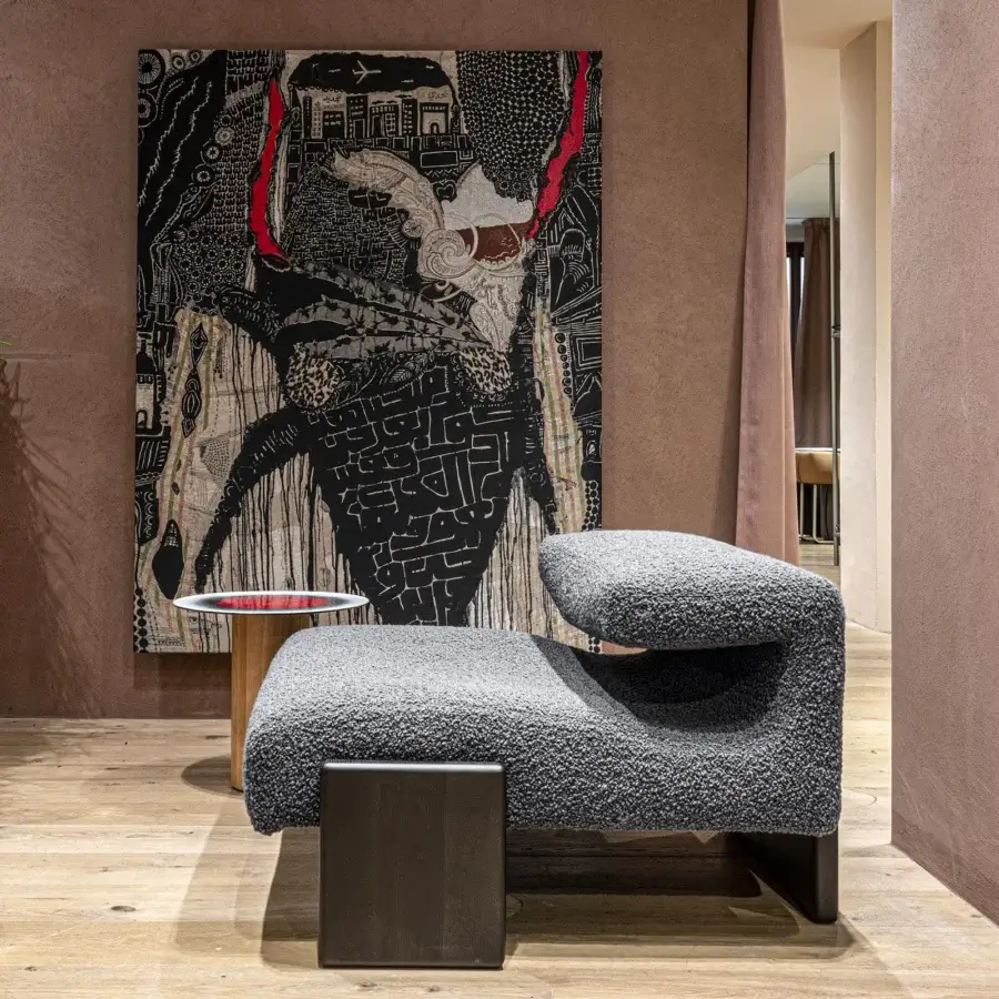Exceptional Moroso loveseat lounge chair with curved form upholstered in medium gray textured textile and ash wood varnished feet