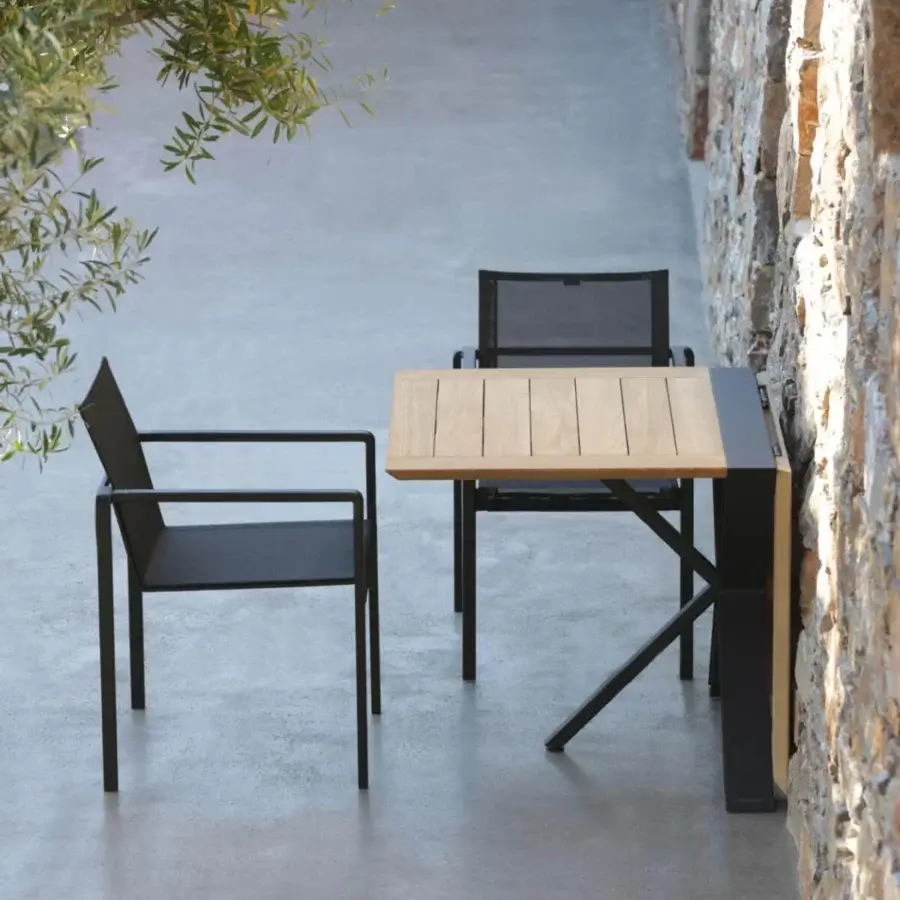 Distinctive Royal Botania Traverse table with light-toned teak wood and dark coated aluminum, built with a unique X-shaped leg structure