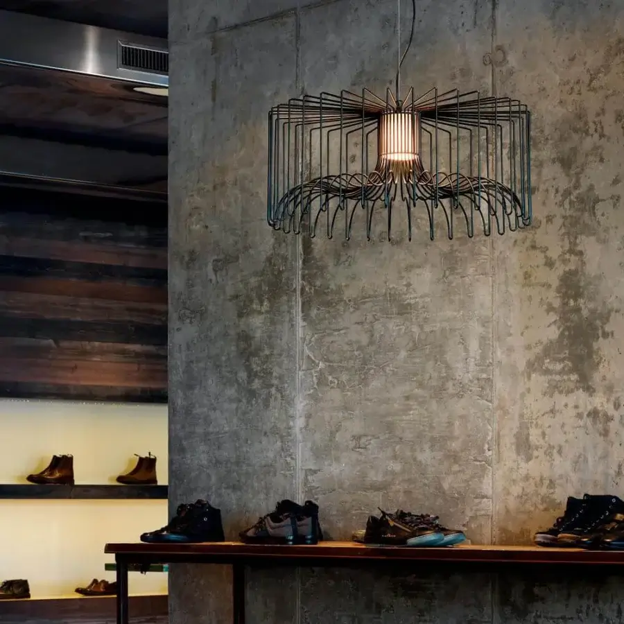 Distinguished Modo Luce Icaro suspension lamp with a matte black painted steel wire cage forming a drum shape around a cylindrical section