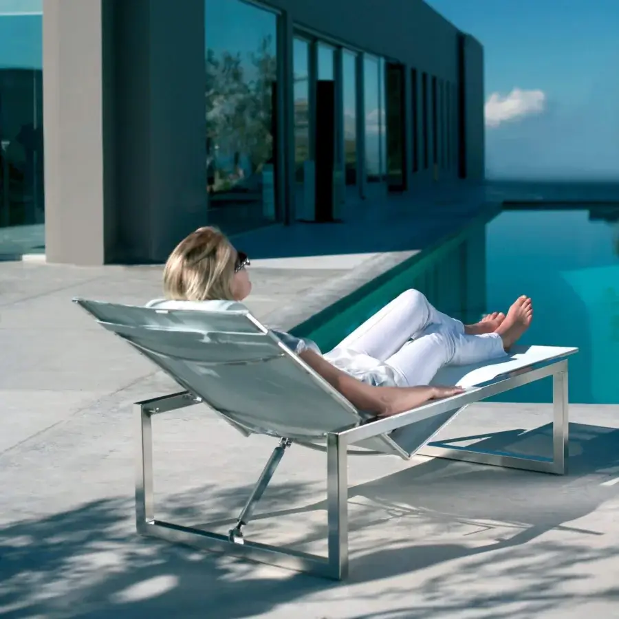 Distinguished Royal Botania Ninix lounger with a sleek stainless steel frame and light-toned Batyline seat exhibiting a polished finish
