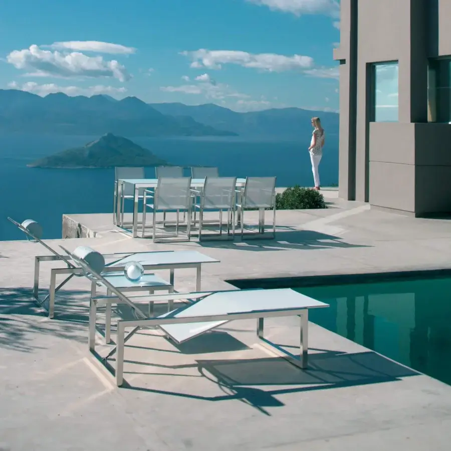 Elegant Royal Botania Ninix lounger with a stainless steel frame and crisp white Batyline seat in a matte finish