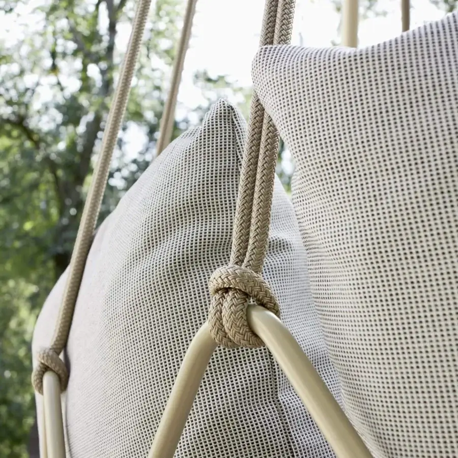 Sophisticated Roberti Rattan Gravity lounge chair with woven light beige textile and light tan powder-coated stainless steel frame