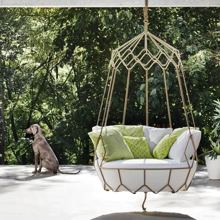 Captivating Roberti Rattan Gravity lounge chair with white cushions, nautical rope and gold powder-coated stainless steel frame