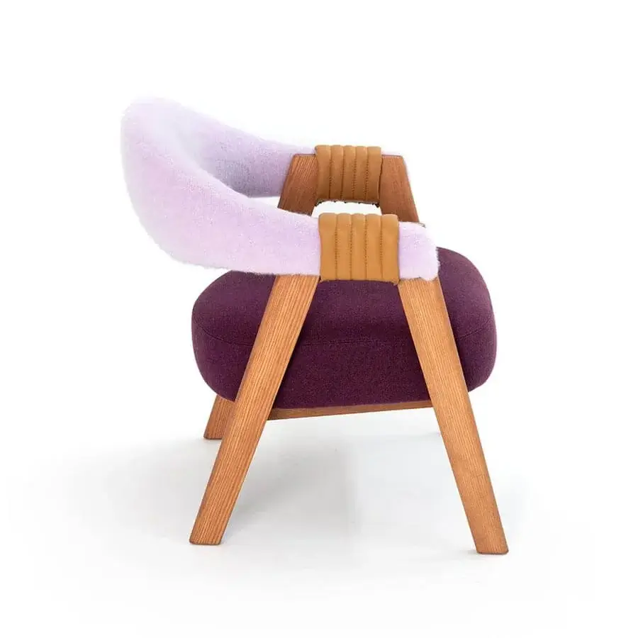 Innovative Moroso Mathilda lounge chair with aubergine seat, light wood frame and tan leather straps in purple textile