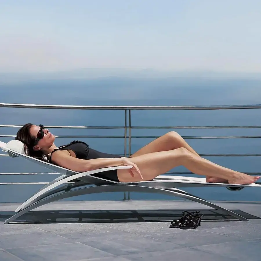 Elegant Royal Botania O-Zon lounger with a gracefully curved silhouette in brushed stainless steel and bright white Batyline seating