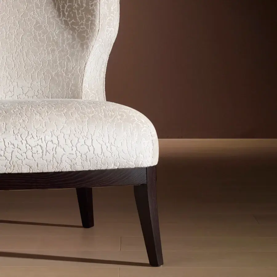 Distinguished Bellavista Grace lounge chair crafted in Italy with curved poplar wood and light textured fabric upholstery with dark stained legs